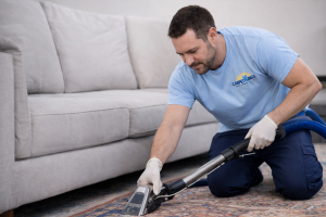 Technician performing professional steam carpet cleaning in a South Florida home